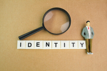 magnifying glass, miniature people with the word Identity. the concept of a person's identity or a...