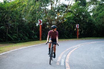 Obraz premium A young female cyclist riding her gravel bike in the mountains.