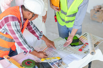 Arabic business teammates working together in office, construction engineer equipment on desk of...