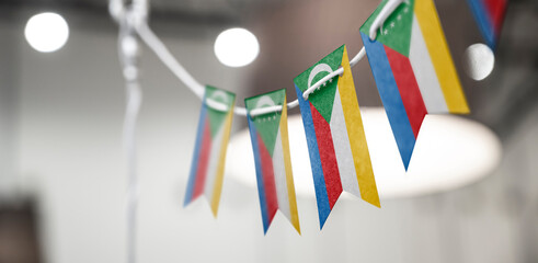 A garland of Comoros national flags on an abstract blurred background