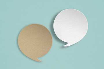 white and brown  speech bubble grunge paper cut on grunge green background. Conceptual image about communication and social media, customer feedback