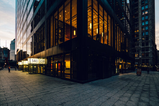 Night street view of Manhattan, roads, and buildings at night. High-quality photo