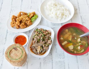 Northeastern Thai  cuisine, Roasted pork liver spicy salad, Deep fried chicken tendons with sweet sauce, Thai spicy soup with herbs and sticky rice