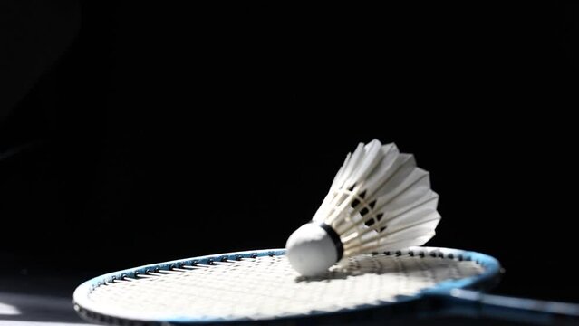 Slow motion of a Shuttlecock falling on a black background. Black background.