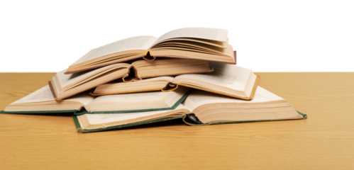Stack open school books on desk