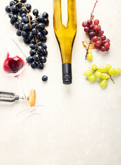 Flat-lay of red and white wine in glasses and corkscrews over grey concrete background, top view,...