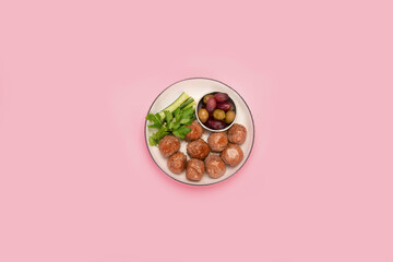 Greek meatballs keftedes on color background.