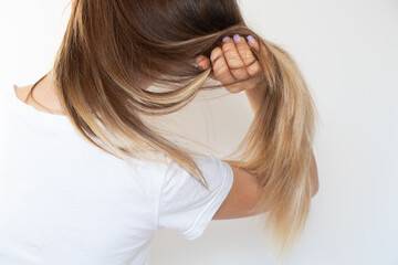 Brown long female hair after alignment with keratin on a white background, hair care