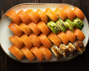 Close up of Philadelphia sushi set with salmon, avocado and cucumber, top view