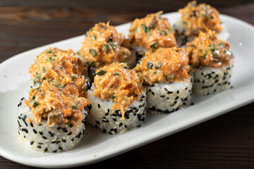 Sushi set on ceramic plate. Set of maki sushi in minimal style. Modern japanese menu concept.