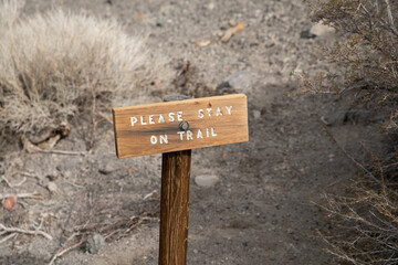 Please stay on trail sign on wooden post.   
