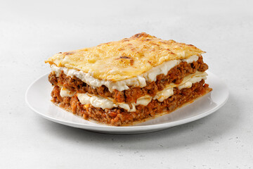 Portion of Homemade Italian lasagna. Delicious Lasagne with bolognese meat sauce on white plate. Hot Tasty Lasagna with Cheese for Menu, recipe.