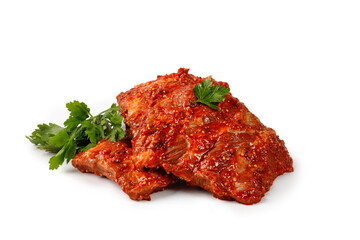 Pork marinated ribs for grill. Uncooked ribs in marinade with parsley, red sauce isolated on white background. Clipping path.