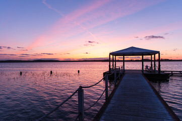 purple sunset with bridge and pavilion at lake