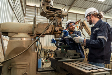 Team of engineers practicing maintenance Taking care and practicing maintenance of old machines in the factory so that they can be used continuously.