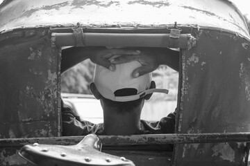 He is sitting relaxed in a pedicab around the Klewer market road, Solo, Indonesia