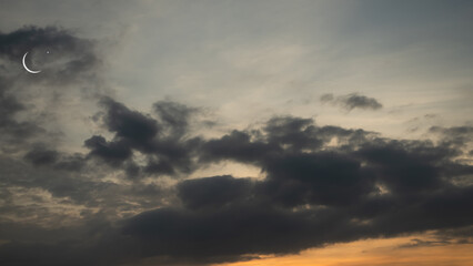 Obraz premium Mubarak Ramadan Month Muslim Islamic Moon Symbols,Crescent Moon and Star on Night Sky Dusk Orange Pink Blue Evening Background,Twilight Free Space for Eid Al Adha,Eid Al Firr,Muharram Religious.