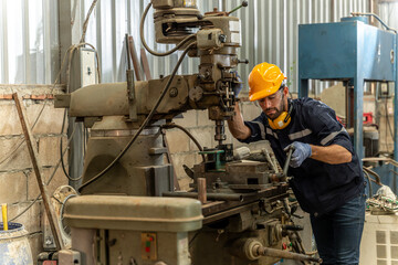 Team of engineers practicing maintenance Taking care and practicing maintenance of old machines in the factory so that they can be used continuously.