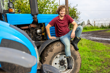 Joyful worker posing for the camera on the farm vehicle