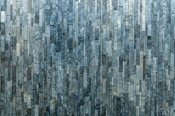Stone cladding wall made of white, gray and black rocks. Decorative stone wall. Beautiful background texture stone lined with granite walls. Vintage texture background, Stone background wall.