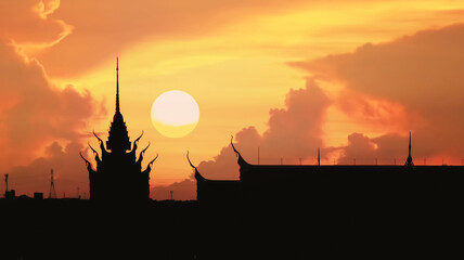 Obraz premium Silhouette image of beautiful Thai temple with sunset on dramatic peaceful summer twilight sky and clouds for holiday travel and meteorology forecast background.