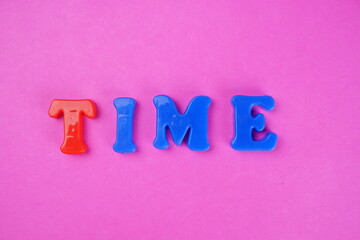 'RELAX TIME' Word spelled out in colorful plastic alphabet.