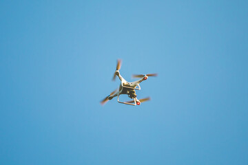 White Drone fly with the blue sky.