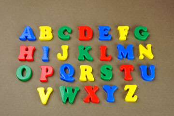 Set of colorful plastic alphabets isolated on background.