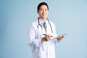 Asian male doctor portrait on blue background