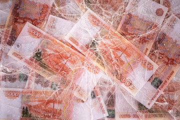 Five thousand rubles are thawed in ice. The Russian currency is frozen.