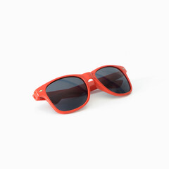 Red sunglasses on white background. Square format