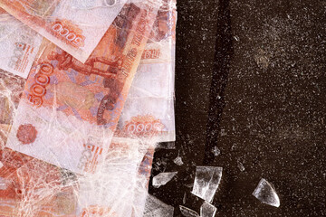 Five thousand rubles are thawed in ice. The Russian currency is frozen.