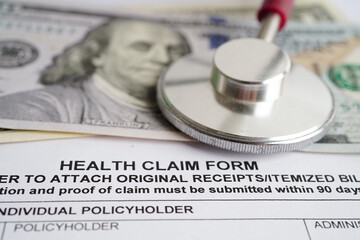 Health claim form with stethoscope and US dollar banknotes, insurance accident medical concept.