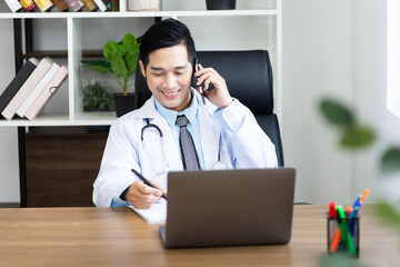 Asian male doctor portrait sitting at work