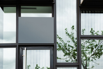 image of a store with windows and a gray space above the door to put a business sign