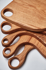 different kind of handmade oak chopping board on white background.