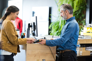 female customer paying with credit card