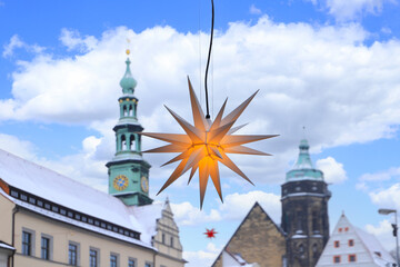 View at the christmas star at the christmas market in Pirna with the town hall in background,...