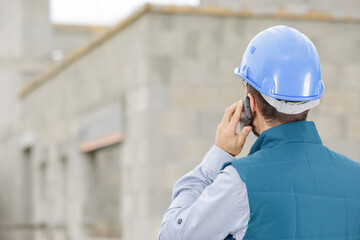 portrait of builder on the phone outdoors