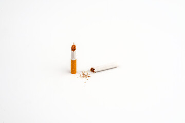 Broken cigarette isolated over the white background