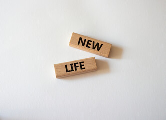 New life symbol. Wooden blocks with words New life. Beautiful white background. Business and New life concept. Copy space.