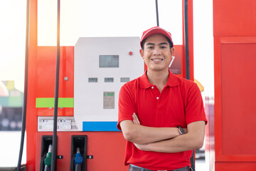 Asian attendant service male worker refuelling car at gas station. Smiling assistant man wear red...