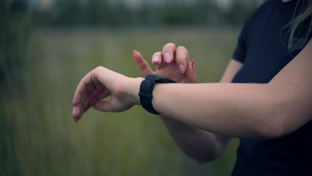 Runner is checking pulse on smartwatch 
