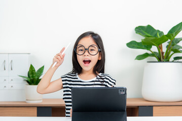 Asian child girl student wow excited on video call learning to studying online class or person...