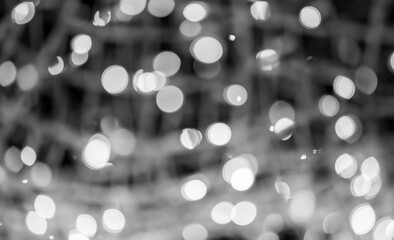 Bright bokeh of lights, blurred night background. New Year celebration.