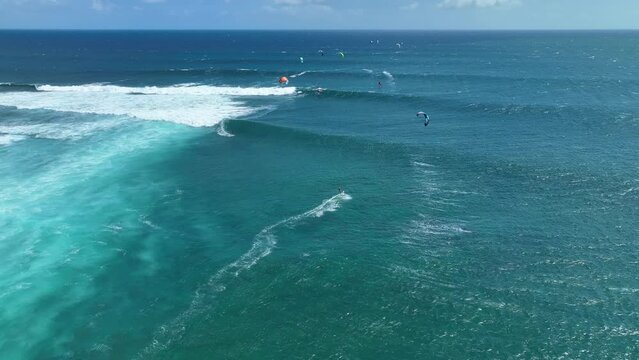 An athlete on a wave board rides the big ocean waves of a living reef in the Indian Ocean. One of the best surf spots on the planet. Sports hobby