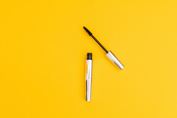 Silver mascara with yellow background