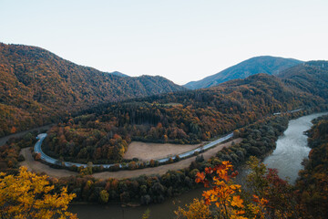 Naklejka premium View of autumn scenery of Domasinsky meander in Zilina region, Slovakia. The Vah River flows past autumn forests in a U-shape