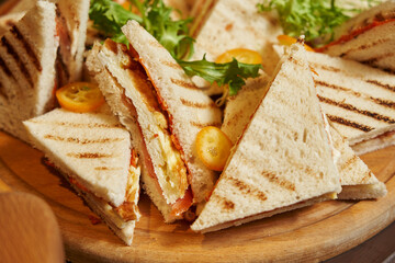 triangular sandwiches on toasted white bread. delicious sandwiches for breakfast. appetizers before the festive banquet