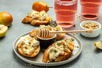 antipasto. Grill toast with caramelized pear, cheese camembert and honey, walnut, Food recipe background. Close up